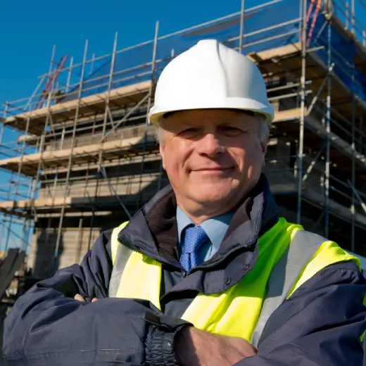 UK construction site manager in hard hat and high-vis vest representing trade business owners using Elite Connector CRM